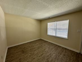 New Bern apartment for rent - an empty living room with wood flooring and a window