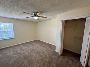 New Bern apartment for rent - an empty bedroom with a ceiling fan and a closet
