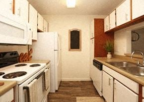 Columbia apartment for rent - A kitchen with white appliances and wooden cabinets.