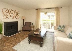 Columbia apartment for rent - A living room with a fireplace, a chair, a couch, and a coffee table.