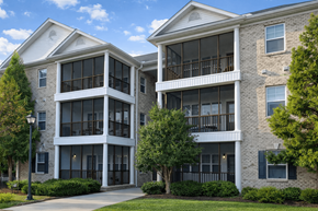 Elon townhouse for rent - Two apartment buildings with balconies and trees in front.
