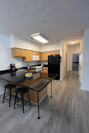 Elon townhouse for rent - A kitchen with a black countertop and a black fridge.