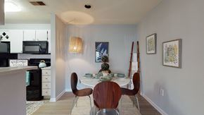 Matthews apartment for rent - a dining room with a table and chairs and a kitchen