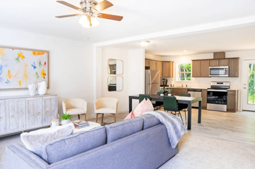 Batavia apartment for rent - A living room with a grey couch and a ceiling fan.