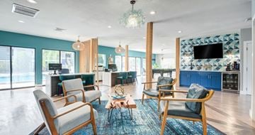 Altamonte Springs apartment for rent - A living room with blue chairs and a television.