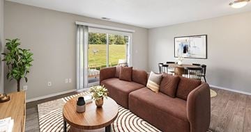 Urbandale apartment for rent - A living room with a brown couch and a coffee table.
