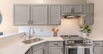 Mesquite apartment for rent - A kitchen with a stove, sink, and cabinets.