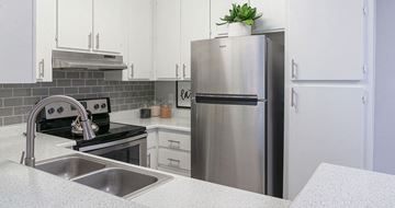 Mesa apartment for rent - A modern kitchen with a stainless steel refrigerator and a black stove top.