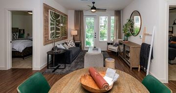 Cedar Park apartment for rent - A living room with a green chair and a wooden table.