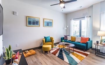Louisville apartment for rent - A living room with a yellow chair and a blue couch.