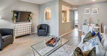 Arlington apartment for rent - A living room with a grey sofa and a glass coffee table.