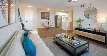 Hoover townhouse for rent - A living room with a white couch and a glass coffee table.