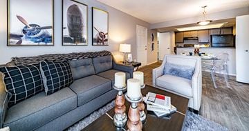 Mesa apartment for rent - A living room with a grey couch and a coffee table with candles on it.