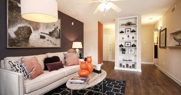 Houston apartment for rent - A living room with a white couch and a black and white rug.
