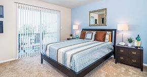 Lakemoor apartment for rent - a bedroom with a bed and a sliding glass door