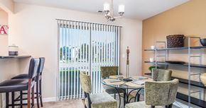 Lakemoor apartment for rent - a dining room with a table and chairs and a window