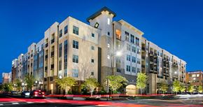 Pensacola apartment for rent - a large apartment building at night with cars driving by