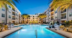Pensacola apartment for rent - a swimming pool at an apartment complex with palm trees