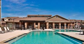 Papillion apartment for rent - a large swimming pool with chairs in front of a building