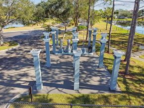 Brandon apartment for rent - A group of blue pillars are in a circle on a paved area.