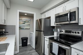 Atlanta apartment for rent - a kitchen with white cabinets and stainless steel appliances