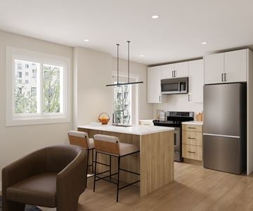 Kelowna apartment for rent - A modern kitchen with a brown leather chair and wooden cabinets.