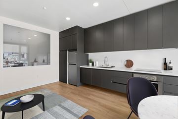 Oakland apartment for rent - A modern kitchen with a dining table and chairs.