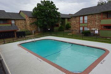 Lancaster apartment for rent - A small pool in a backyard surrounded by a black fence.