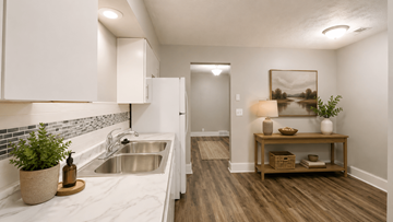 Bellevue apartment for rent - A kitchen with white cabinets and a marble countertop.