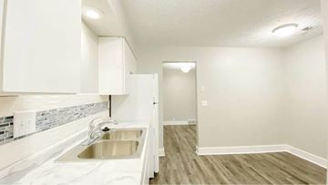 Bellevue apartment for rent - A kitchen with white cabinets and a stainless steel sink.