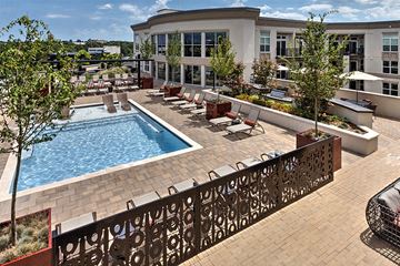 Charlotte apartment for rent - A pool surrounded by a fence and chairs.