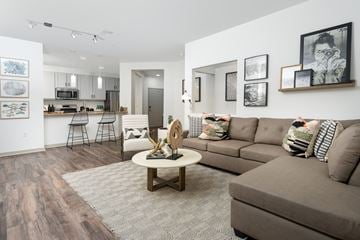 San Diego apartment for rent - A living room with a grey couch and a coffee table.
