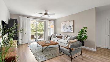 Issaquah townhouse for rent - A living room with a grey couch, a coffee table, and a painting on the wall.