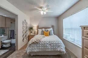Benton apartment for rent - A bedroom with a bed, dresser, and ceiling fan.