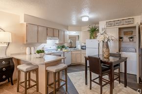 Benton apartment for rent - A kitchen with a table and chairs in the middle.