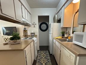 Benton apartment for rent - A kitchen with white appliances and a clock on the wall.