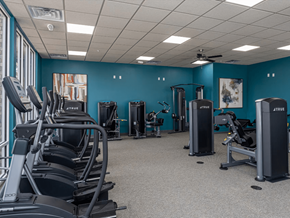 Fayetteville apartment for rent - a large fitness room with cardio equipment and exercise machines