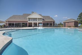 Benton apartment for rent - A large swimming pool in front of a house.