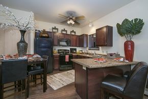 Benton apartment for rent - A kitchen with brown cabinets and a black counter.