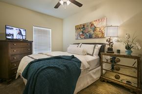Benton apartment for rent - A bedroom with a bed, dresser, and ceiling fan.