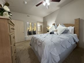 Bryant apartment for rent - A bedroom with a large bed and a dresser.