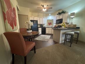 Bryant apartment for rent - A kitchen with a table and chairs in the foreground.
