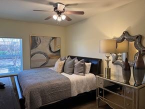 Norman apartment for rent - A bedroom with a bed, nightstand, and a painting on the wall.