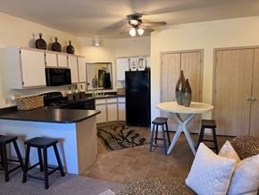 Norman apartment for rent - A kitchen with a black refrigerator and a black counter top.
