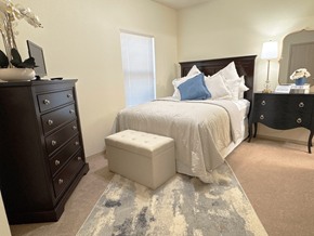 Little Rock apartment for rent - A bedroom with a bed, nightstand, and dresser.