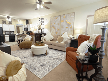 Little Rock apartment for rent - A living room with a white rug and a brown chair.