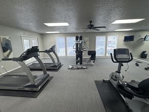 Benton apartment for rent - A gym with treadmills, elliptical machines, and a weight machine.