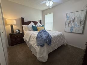 Benton apartment for rent - A bedroom with a large bed and a painting on the wall.