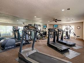 Texarkana apartment for rent - A gym with treadmills, elliptical machines, and other exercise equipment.