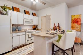 Stillwater apartment for rent - a kitchen with white appliances and a bar with a dining table